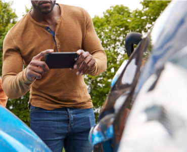 Man taking picture of a car accident