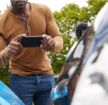 Man taking picture of a car accident